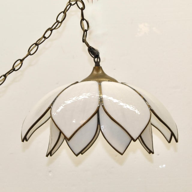 This mid-century modern hanging pendant light in a lotus flower form. Two tiers of sculpted, milk-white slag glass petals...