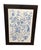 This framed ceramic tile wall art panel showcases a classic blue-and-white botanical scene inspired by traditional...