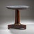 Round side table dating to around 1830, featuring a dark grey marble top. The base is made of mahogany veneer with a...