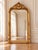 This elegant late 20th-century French Louis XVI–style floor mirror combines classical neoclassical proportions with a warm...