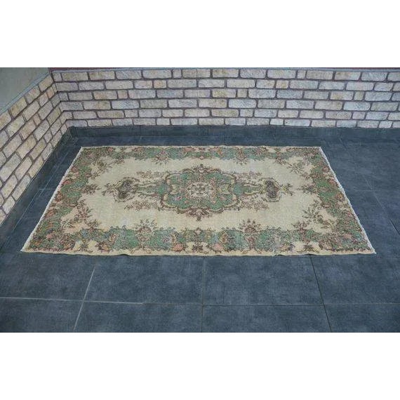 This is a vintage Turkish Oushak rug from the 1960s. The piece was hand-knotted.