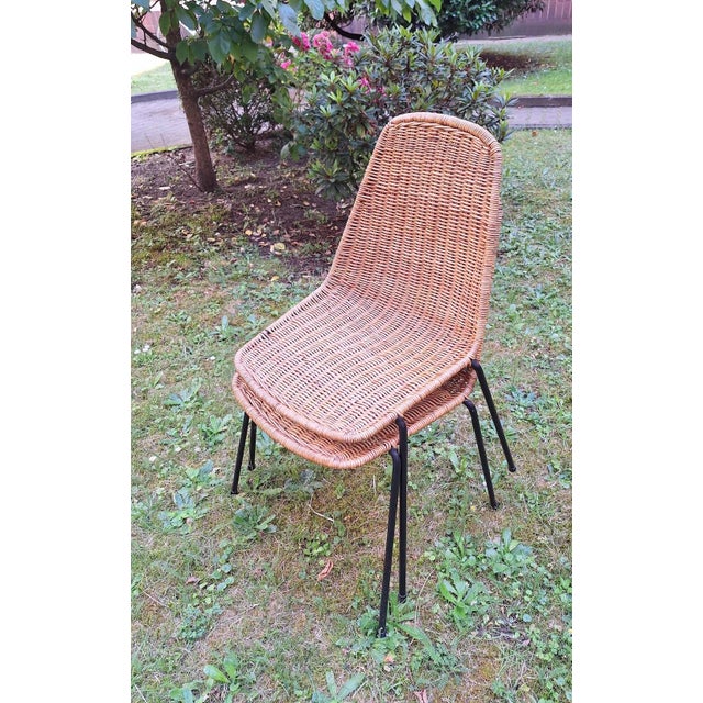 A pair of mid-century rattan dining chairs on slender iron frames by Gian Franco Legler I have official proof of...