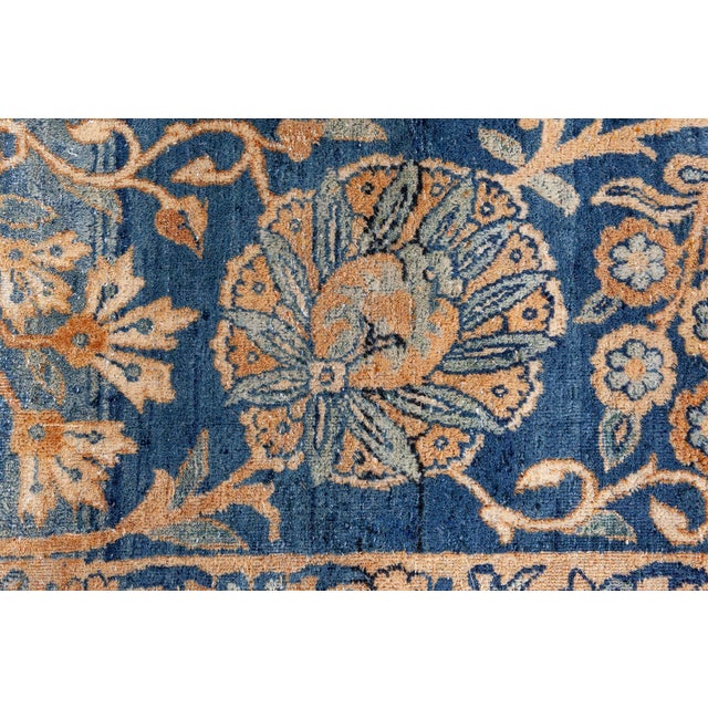 A late 19th century Persian Kirman (Kerman) antique carpet, the apricot field with an allover trellis of leafy vines,...