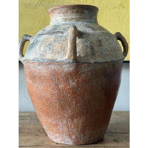 An Antique Berber Vase with wonderful time worn colour and patina, 4 handle neck and hand painted geometric band decoration.