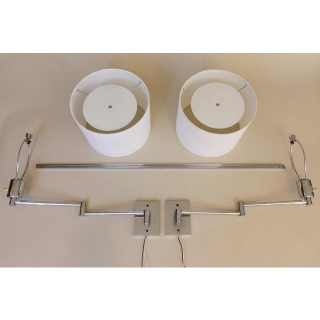 A brilliant and impressive matched pair of George Hansen New York articulating swing arm wall lamps circa 1950's....