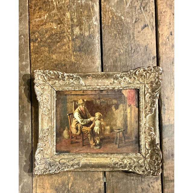 This evocative antique oil painting captures a tender narrative moment, rendered with the warmth and sincerity typical of...
