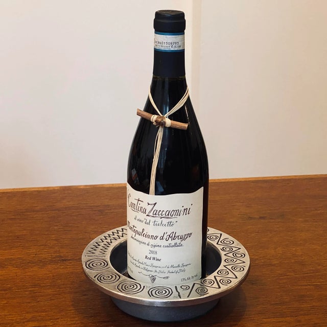 Vintage wine bottle coaster with a postmodern abstract design around rim and removable cork liner. Bottom with felt and...