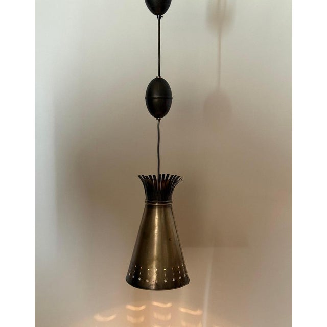 Elegant Scandinavian Diablo pendant light dating from the 1950s–1960s, crafted in solid brass and featuring a beautifully...