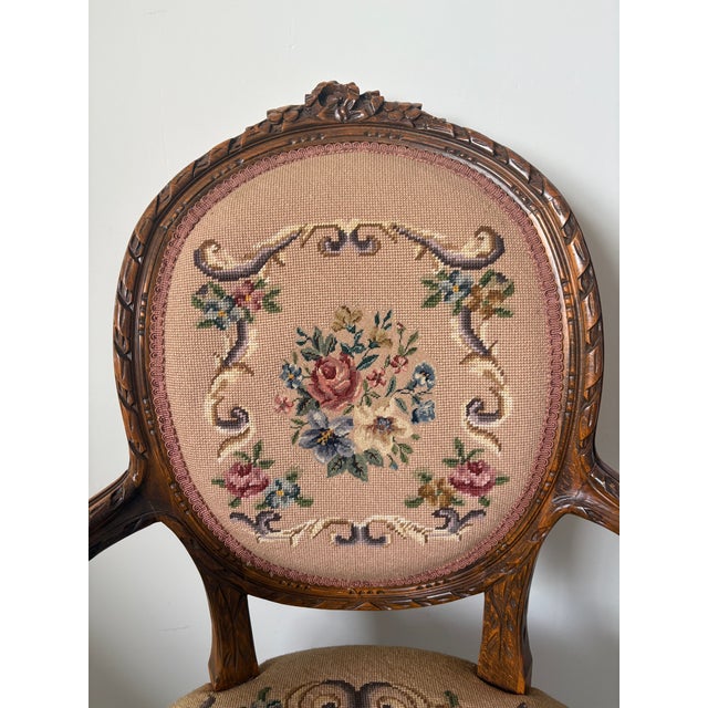 Elegant Louis XVI armchair featuring a classic carved wood frame with refined neoclassical details. This timeless piece...