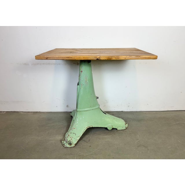 Green industrial table made in former Czechoslovakia during the 1960s. Made of cast iron and wood.