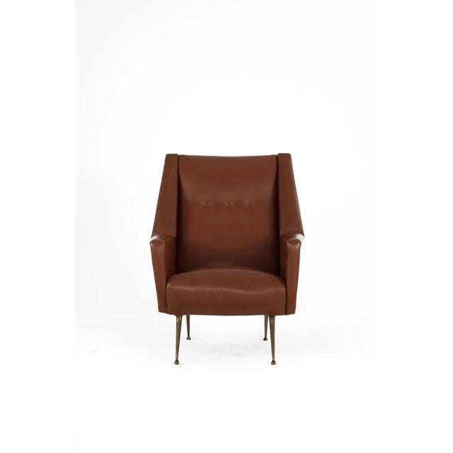 Chair - Italy, 1950s. The chair has the original faux leather cover and brass legs.