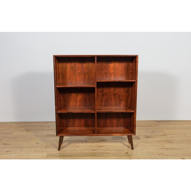 The shelf made of rosewood in Denmark in the 1960s. The shelf has interesting graining. Possibility to adjust the height...