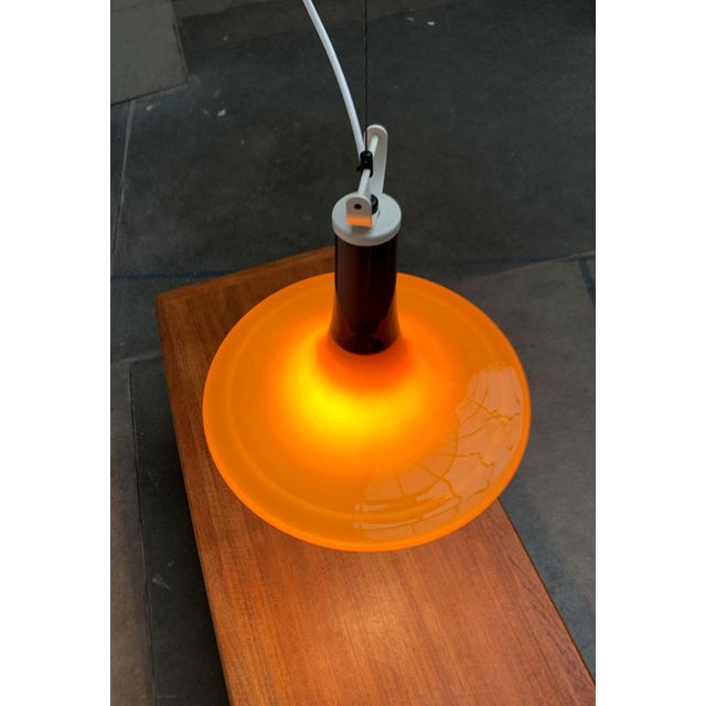 Elegant glass pendulum from the renowned manufacturer Peill & Putzler, Germany. The design from the 1970s shows a typical...