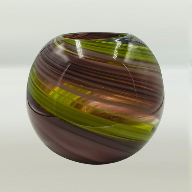 Mid-century modern spherical art glass vase, hand-blown in Murano, Italy, circa 1960. This exquisite piece features a...