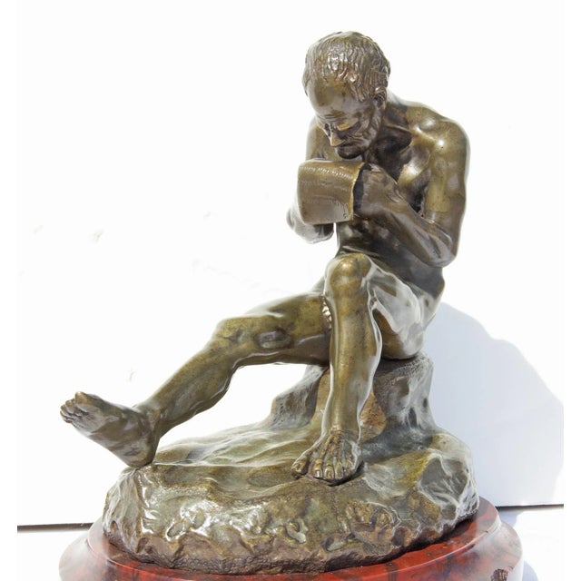 Antique bronze sculpture of man reading a letter or proclamation. Marble base. 19th century. Unsigned