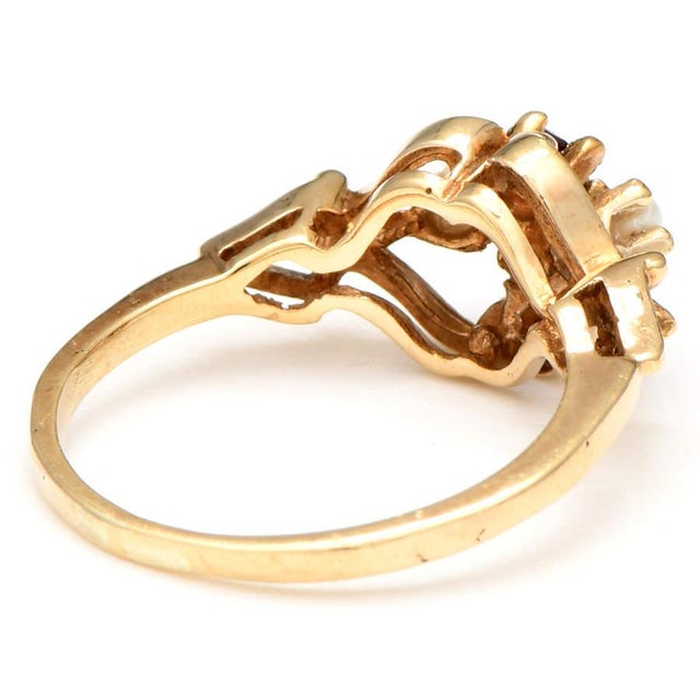 A cluster of round garnet and pearl stones create a minimalist but classic look. The ring looks sophisticated enough for a...