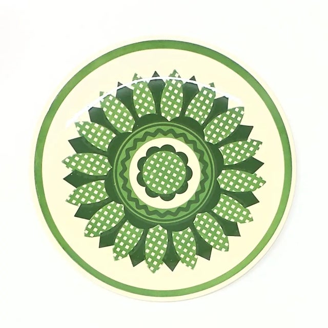 Multi-colored decorative plates, group of 6. This is a colorful set of decorative plates, featuring geometric flower or...