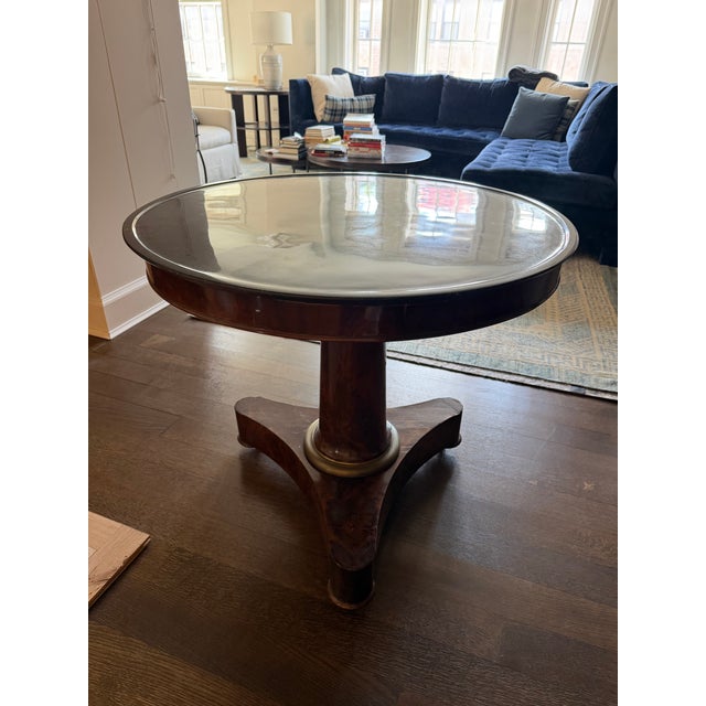 Burled Wood Empire pedestal entry table, black polished Belgium limestone top with column tripod base with bronze accent