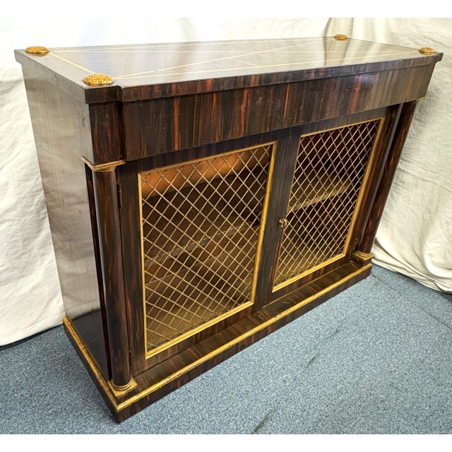 Vintage Hollywood Regency style wood sideboard cabinet. The piece has been painted in a faux bois style to look like wood...