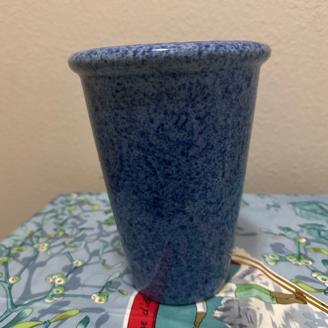 An elegant mid-century modern style ceramic vase featuring a striking, deep cobalt blue spongeware glaze. The vessel...