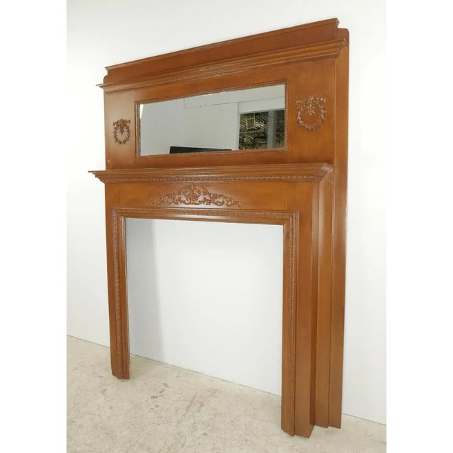Vintage Victorian style wood mantel with an over mantel mirror and detailed ornate carvings. Good condition with minor...