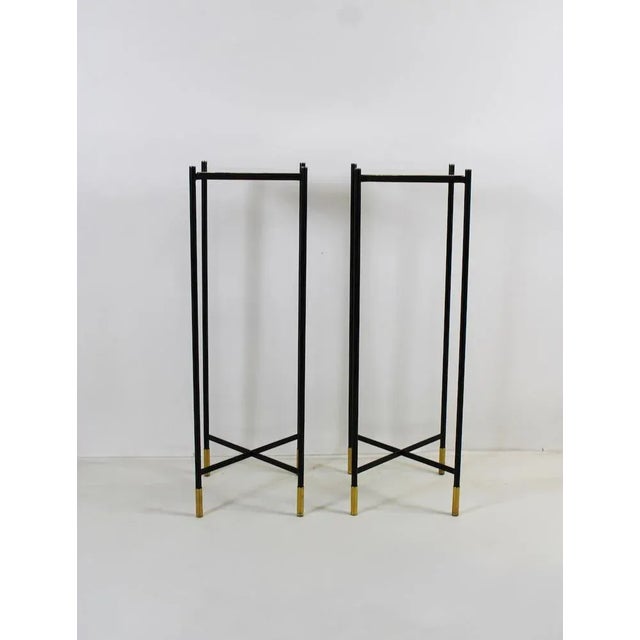 Elegant vintage columns with structure entirely in black metal and shelf and details in mirrored brass. Era: 1970 Origin:...