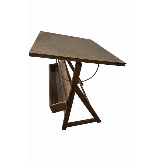 DESCRIPTION This is a genuinely old drafting table, built for working hands, not decoration. Solid wood construction with...