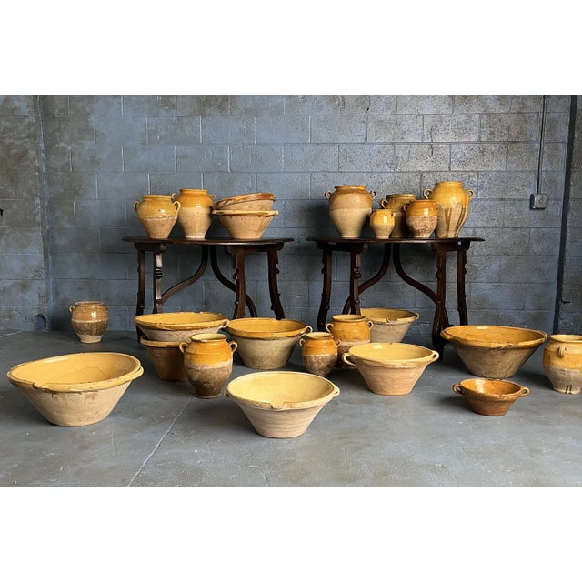 A vintage French terracotta confit pot, traditionally used in the 19th to early 20th century for preserving foods like...