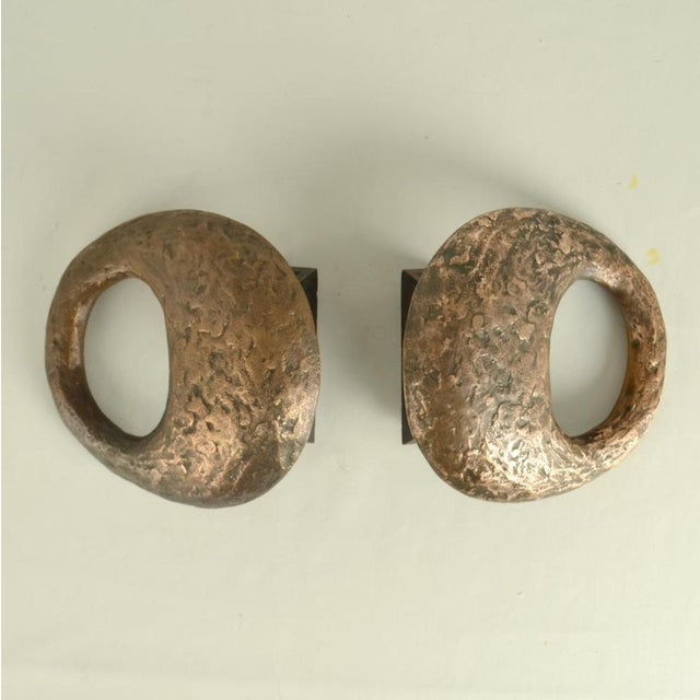 Pair of sculptural round push and pull door handles with an articulated oval hole make a good grip. They are very...