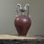 Chinese amphora shaped Sancai style vase featuring a pair of sculpted handles that terminate in dragon heads. The handles...