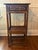Chinese export side table in burnt tortoiseshell bamboo with black top. The apron features Chinese Chippendale fretwork...