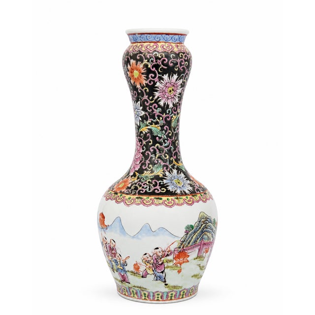 A decorative Chinese porcelain vase with a graceful baluster form, flared rim, and richly detailed hand-painted style...