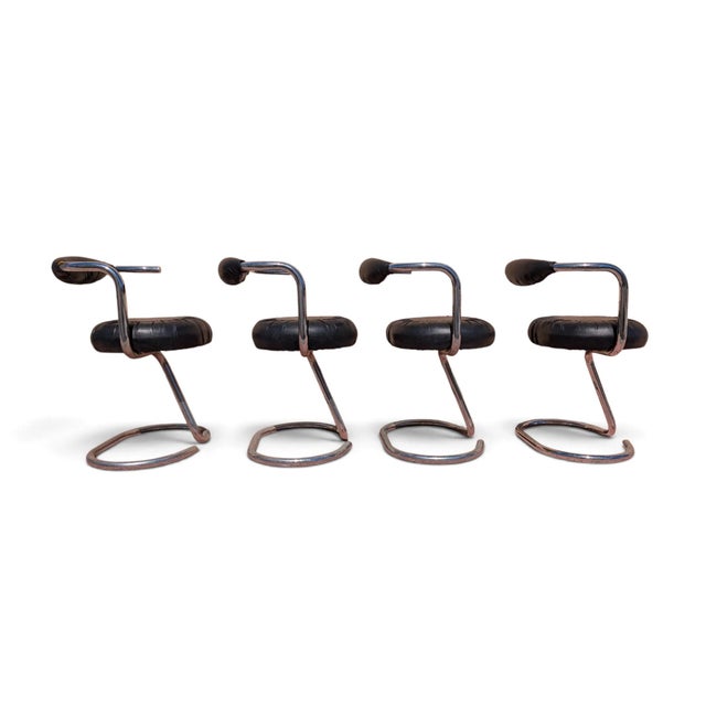 These four chairs, known as the "cobra" model and inspired by the celebrated style of designer giotto stoppino, date back...