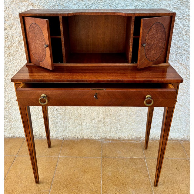 Elegant spanish writing desk from the 1940s, with fine veneer work and clean, classic lines. The desk features a spacious...