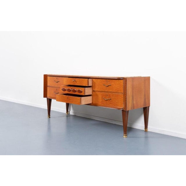 Beautiful Italian design sideboard/chest of drawers from 1950s. It features 7 drawers, top with a marble inlay, brass feet...