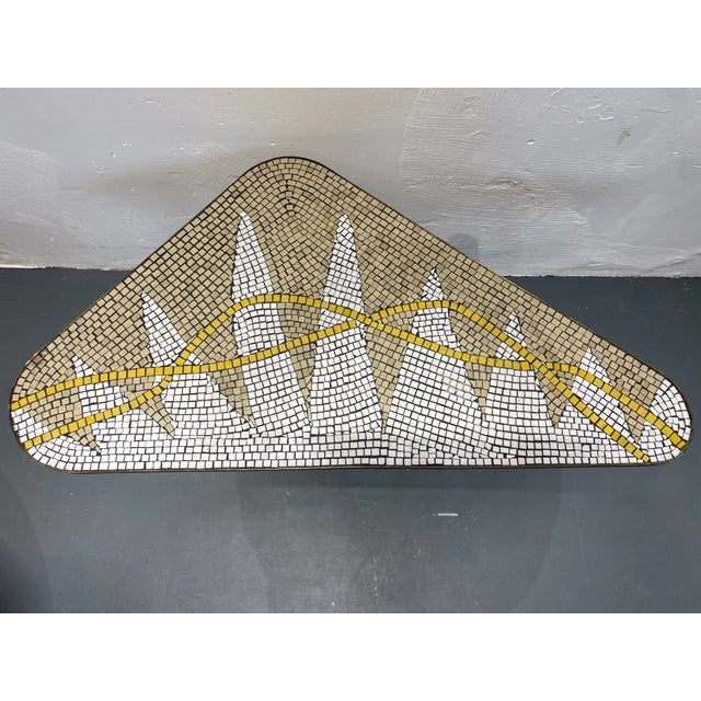 An extravagant mid-century kidney-shaped table with a mosaic design from the 1960s. The table comes from a smoke-free,...