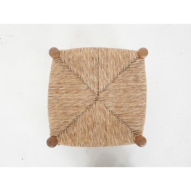 About this item Small wooden (foot) stool with rattan seating. One string is missing.