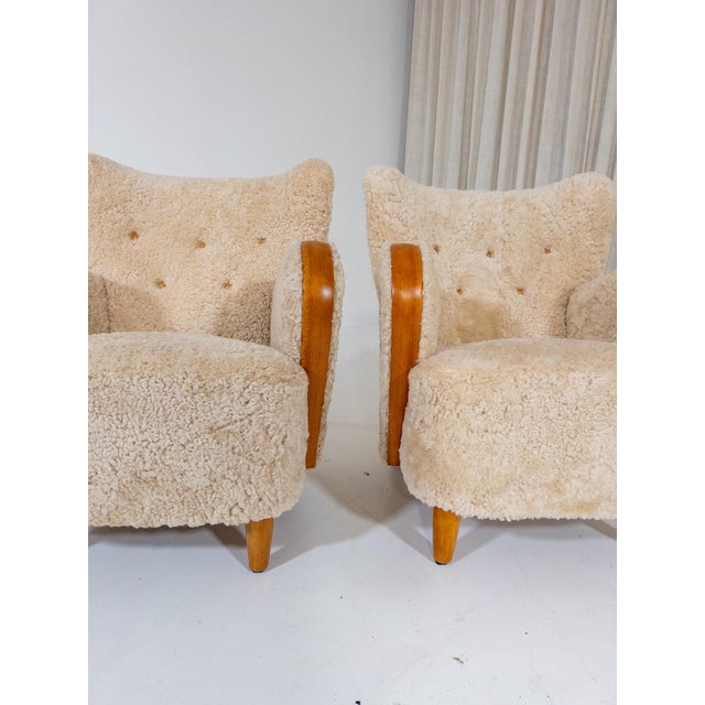An exceptionally fine and rare pair of armchairs in classic Swedish Modern style from the 1940s. Newly upholstered in...