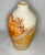 A great vintage piece of Nedmahi pottery with swirled orange, black, gray, white, and red. The piece is older with patina....