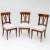 Set of three Biedermeier chairs in walnut with white upholstered seats and backs with three struts. The chairs stand on...