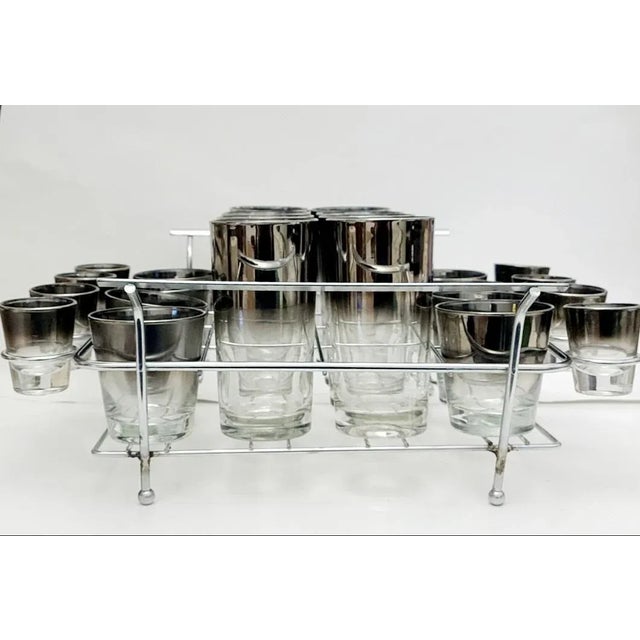Mid century set of 24 silver mercury fade glasses, in chrome carrier. They have an ombre effect from silver at the top to...