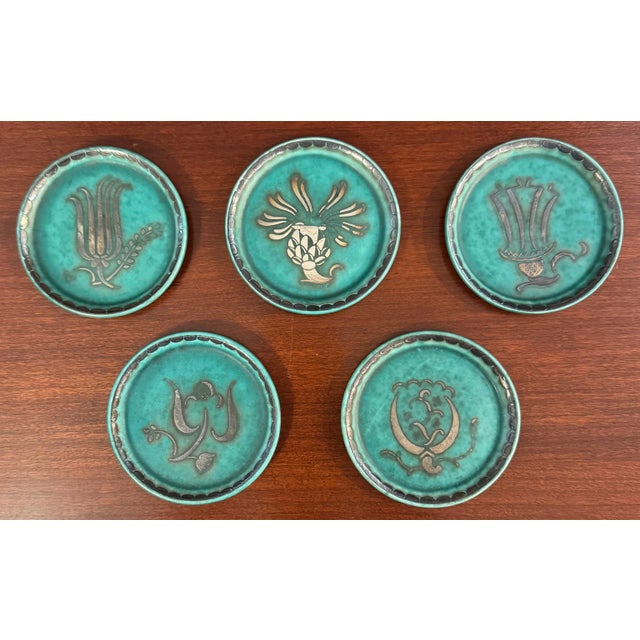 A striking set of five vintage Swedish Argenta pottery coasters by the renowned Swedish ceramic manufacturer Gustavsberg....