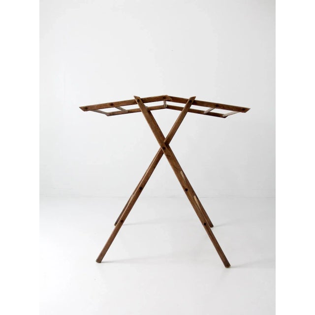 A rare antique wood drying rack featuring a unique fold-up top that can be used flat or hung at an angle. Multiple spindle...