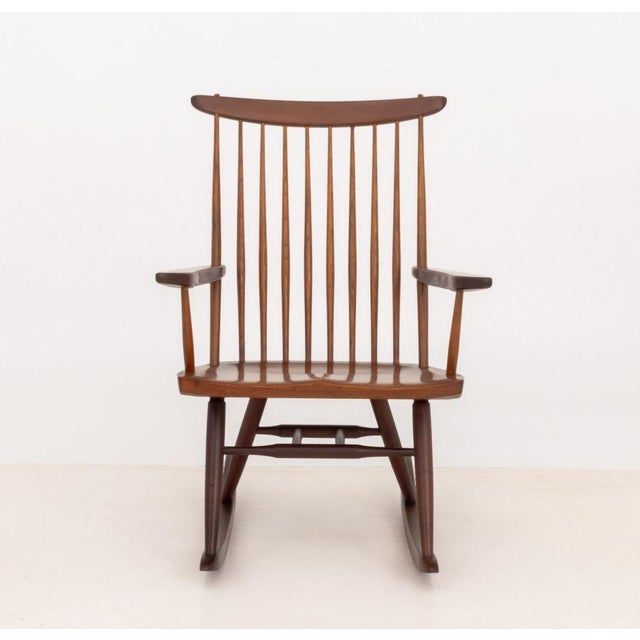 George Nakashima (American, 1905-1990) American Walnut New Rocking Chair, 1962, with spindle back. 35.75" H x 24.5" W x...
