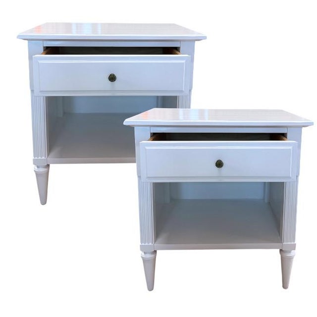 A sophisticated pair of American of Martinsville one-drawer nightstands, professionally refinished in a crisp white...