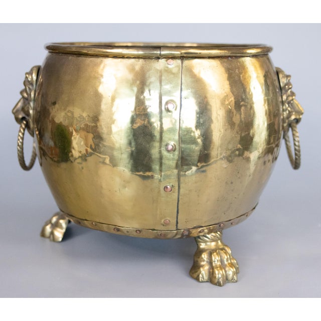 A superb large antique English hammered brass tripod footed cauldron, jardiniere, planter, log bin, or champagne bucket,...