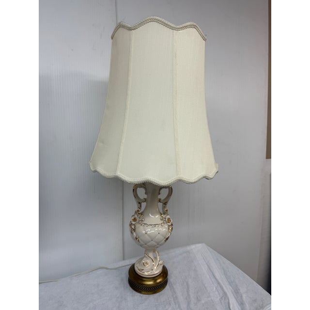 Design Plus Gallery presents a Pair of Porcelain Table Lamps with Gold Decorative Elements. The vintage lamps give off a...