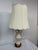 Design Plus Gallery presents a Pair of Porcelain Table Lamps with Gold Decorative Elements. The vintage lamps give off a...
