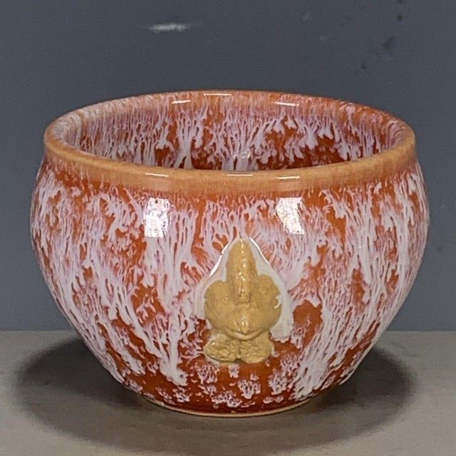 This is a striking vintage Chinese porcelain teacup , featuring a dramatic flambé glaze and applied beast-head handles....