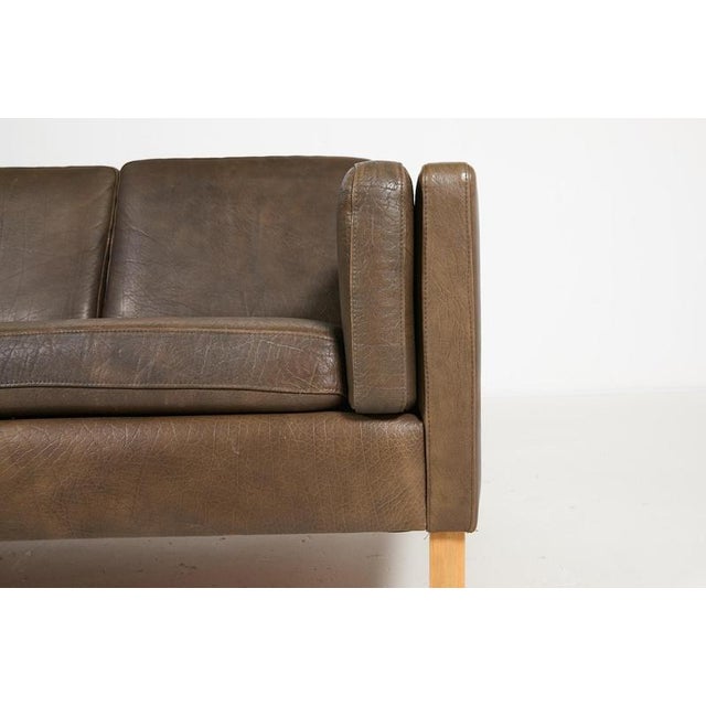 Two-seat brown leather Vemb Polstermøbelfabrik sofa on varnished maple legs, loose cushions. Scandinavian classic in the...
